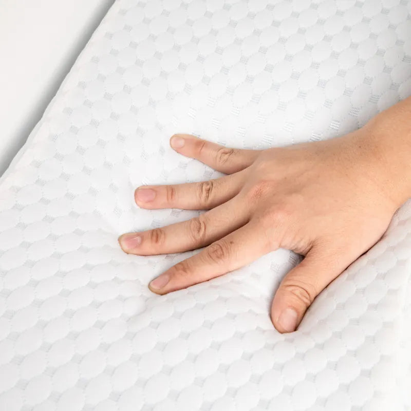 Main appuyant sur la mousse à mémoire de forme de l’oreiller gel rafraichissant 60x30cm, illustrant la souplesse et le soutien ergonomique du coussin