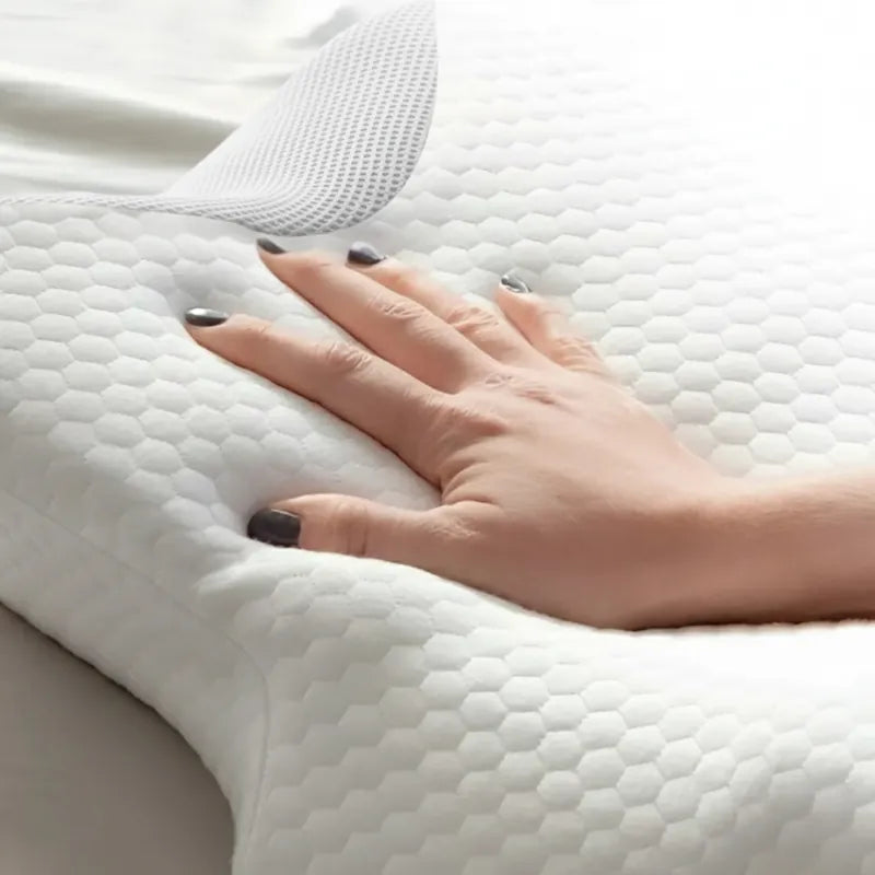 Oreiller a memoire de forme cervical blanc 40x60 cm - gros plan sur la mousse viscoelastique reactive a la pression de la main.